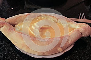 The traditional Georgian dish is the Adjara khachapuri: dough in the shape of a boat, suluguni cheese, an egg