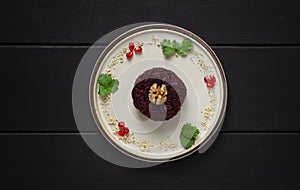 Traditional Georgian dish, beetroot phali, on a black wooden table, horizontal, no people,