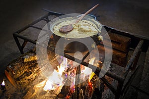 Traditional georgian food, hominy mamaliga is cooked in the large cooking pot on fire