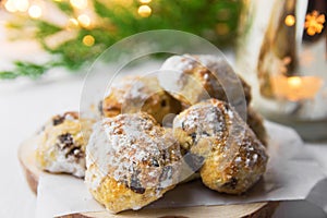 Traditional German Austrian Swiss Christmas pastry mini stollen cakes or cookies in wicker basket and on wood serving board