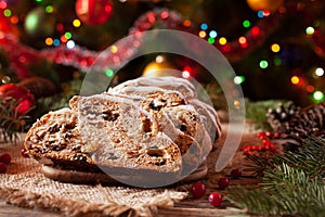 Traditional German Christmas cake Stollen with Marzipan, Nuts and Berries. Celebration decorations.