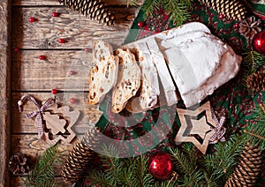 Traditional German Christmas cake Stollen with Marzipan, Nuts Berries and Raising. Holiday xmas celebration decorations.