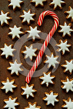 Traditional German Christmas Cookies Home Baked Glazed Cinnamon Stars with Nuts Candy Cane Pattern on Rusty Dark Background