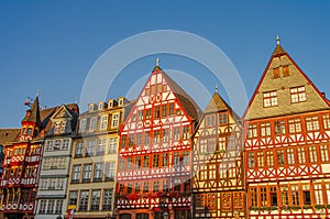 Traditional German old half-timbered houses fachwerk at historical downtown in Frankfurt, Germany, during colorful sunset,