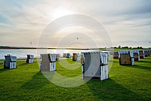 Traditional German roofed wicker beach chairs on the beach of North Sea, Nordsee, Germany, Wattenbeer. Beach with relax