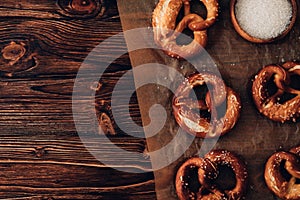 Traditional German Savory Lye Pretzel with Salt on Piece of Parchment Paper. Poster Banner for Bakery. Copy Space.Top