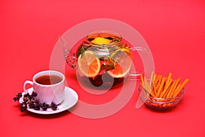 Traditional glass teapot with tea. A white mug. With slices of yellow lemon.with mint