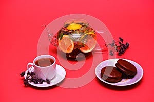 Traditional glass teapot with tea. A white mug. With slices of yellow lemon.with mint