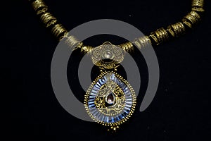 Traditional gold jewellery necklace artifact.on black background.