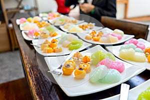 Traditional Golden and colorful Thai Dessert; JaMongKut, SaNayChan, ThongAek, MedKaNoon and Woon are set in seperated square white photo