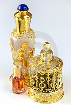 Traditional golden ornate flask of Arabian oud oil perfumes. Isolated white background