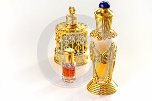 Traditional golden ornate flask of Arabian oud oil perfumes. Isolated white background. Copy space