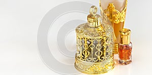 Traditional golden ornate flask of Arabian oud oil perfumes. Isolated white background. Copy space