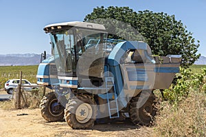 Traditional grape mechanical harvesting machine on a Swartland wine farm photo