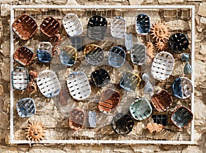 Traditional Greek ceramics on display on old stone wall