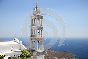 Traditional greek church bell tower and the Aegean sea in Tinos, Greece