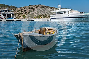 Traditional Greek fishing boat is moored near the coast at Symi island, Greece