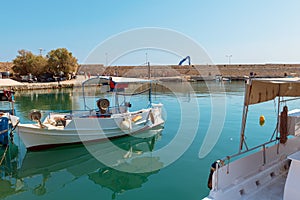 Traditional Greek fishing boats are moored in harbor of Rethimno town