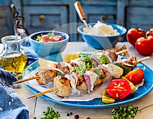 Traditional Greek Food, Souvlaki, Grilled Chicken, Vegetables, Tzatziki, Mediterranean Cuisine, Wooden Table, Overhead View.