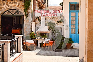 Traditional greek outdoor restaurant on terrace, street village restaurant