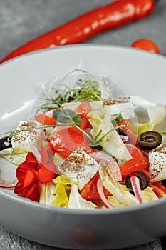 Traditional greek salad with fresh vegetables, feta cheese and olives. Top view. Selective focus
