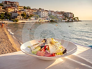 Traditional Greek Salad on a table near the beach in a traditional Greek Tavern in Skala Marion, Thasos, Greece