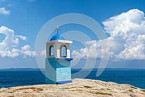 Traditional Greek small church or chapel on sea backround