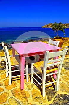 Traditional greek tavern on the beach of Mediterranean sea