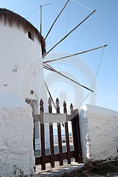 Traditional Greek Windmill with Thatched Roof and Gate
