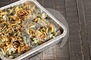 Traditional Green Bean Casserole with Fried Onions on a Wooden Table