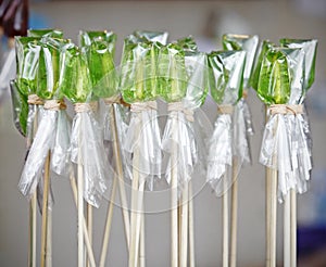 Traditional green candy on stick.