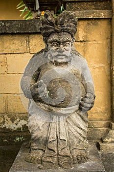 Traditional guard statue carved in stone on Bali