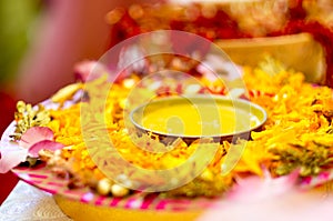 Traditional Haldi turmeric kept on a flower plate for the hindu marriage ceremony