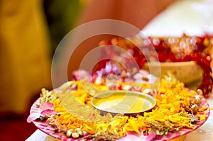 Traditional Haldi turmeric kept on a flower plate for the hindu marriage ceremony