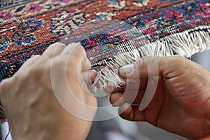 Traditional hand sewing fixing old vintage antique persian carpet up close