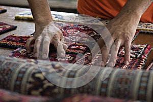 Traditional hand sewing fixing old vintage antique persian carpet up close