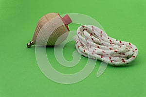 Traditional handmade wooden toy with metal tip and cord