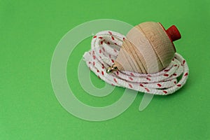 Traditional handmade wooden toy with metal tip and cord