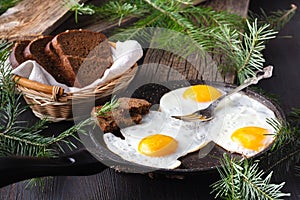 Traditional healthy easy quick breakfast meal made of two fried eggs served on a frying pan