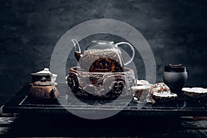 Traditional herbal tea in transparent glass teapot. Studio shot