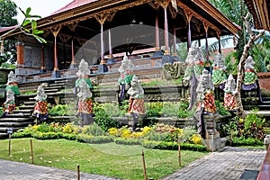 Traditional Hindu Balinese temple with stone statues of Gods and Demons