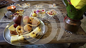 Traditional Hindu Ceremony: Wooden Tabletop adorned with Fruits, Ritualistic Arts, and Clay Pot in Uttarakhand, India