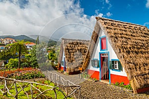 Traditional historic thatched houses with strawy roofs on Madeira island, Santana, Portugal photo