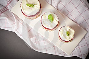 Traditional holiday layered fish salad Herring under fur coat served in culinary rings. Top view on dish. Copy space image