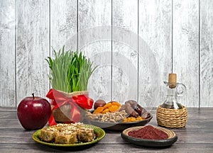 the traditional holiday of the vernal equinox Nawruz. Festive table in honor of Navruz. Wheat with a red ribbon