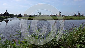 Traditional Holland Windmills in Zaanse Schans, Netherlands. Touristic Village near the Amsterdam with the windmills and