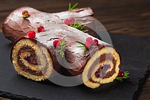 Traditional homemade Christmas cake. Yule log or Buche de Noel.