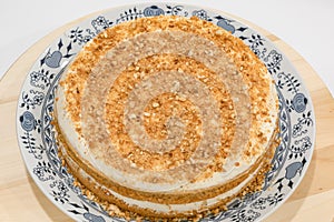 Traditional homemade czech Honey cake MedovnÃ­k with cream and grinded nuts topping