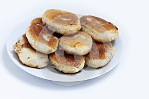 Traditional homemade fried patties or pies made of yeast dough in a rusticstyle on white plate