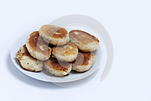 Traditional homemade fried patties or pies made of yeast dough in a rusticstyle on white plate